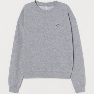 Lightweight gray sweatshirt with a printed design.